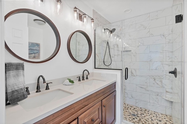 bathroom with a shower with door and vanity