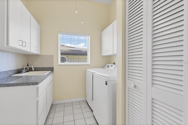 laundry area with cabinets, sink, independent washer and dryer, and light tile patterned flooring