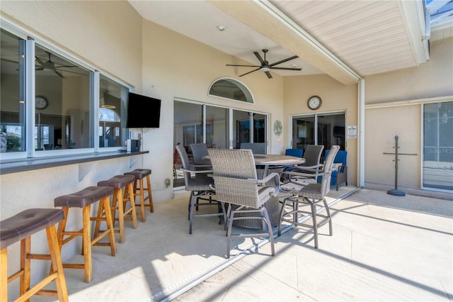 view of patio / terrace with ceiling fan and an outdoor bar