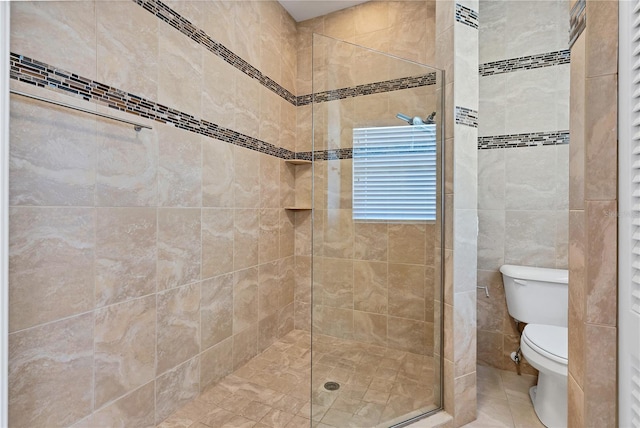 bathroom with walk in shower, tile walls, and toilet