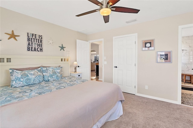 bedroom with ceiling fan, carpet floors, and ensuite bath