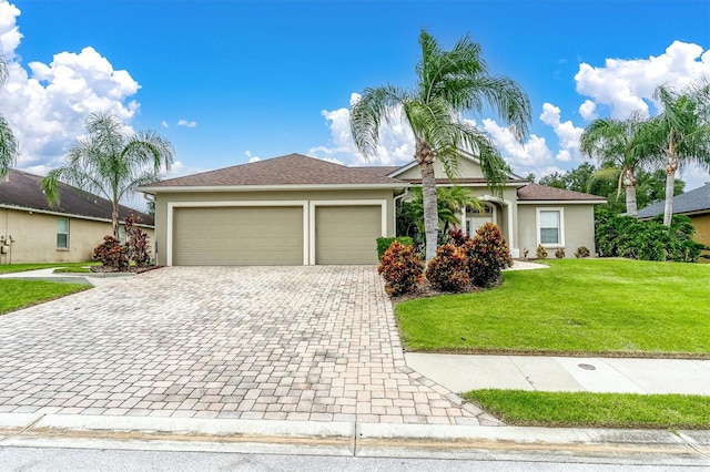 ranch-style home with a garage and a front lawn