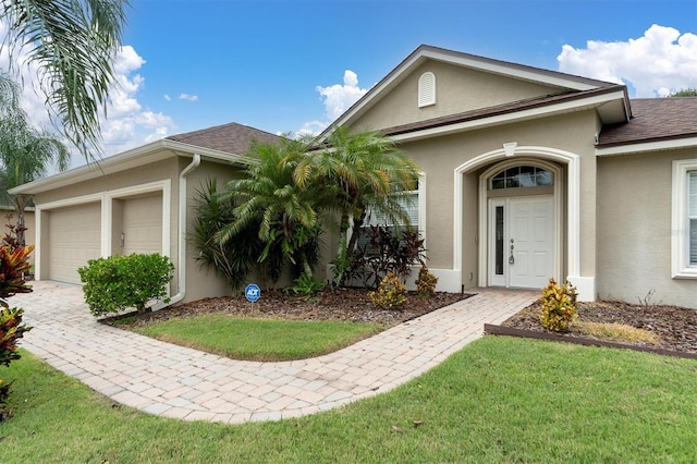 view of front facade with a front lawn and a garage