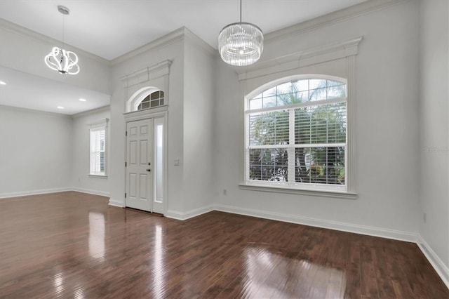 foyer featuring a healthy amount of sunlight, dark wood-type flooring, and a chandelier