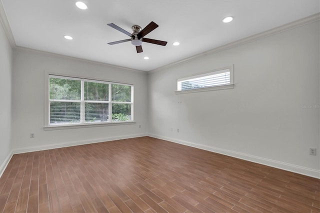 empty room featuring hardwood / wood-style floors, ceiling fan, and ornamental molding