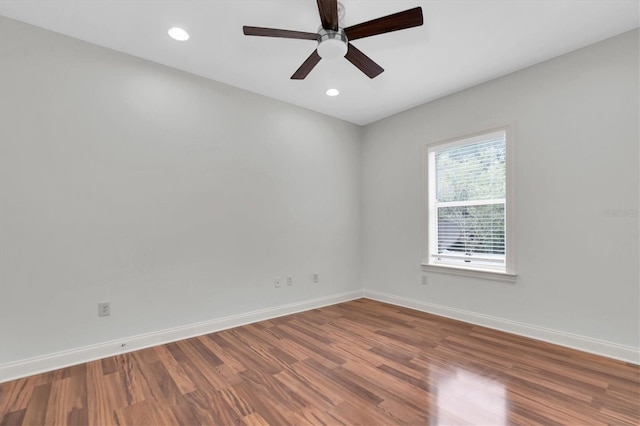 spare room with wood-type flooring and ceiling fan