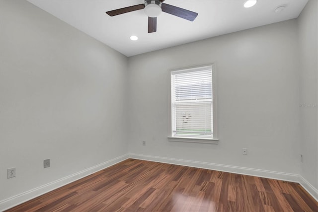 spare room featuring ceiling fan and dark wood-type flooring