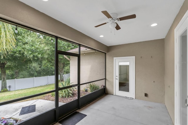 unfurnished sunroom with ceiling fan and a healthy amount of sunlight