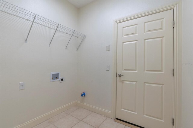 clothes washing area featuring hookup for an electric dryer, hookup for a washing machine, and light tile patterned flooring