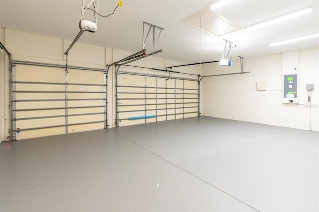 garage with electric panel and a garage door opener