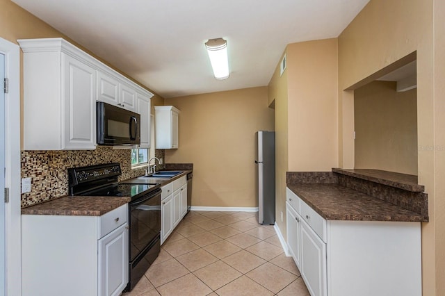 kitchen featuring black appliances, white cabinetry, sink, and light tile patterned floors