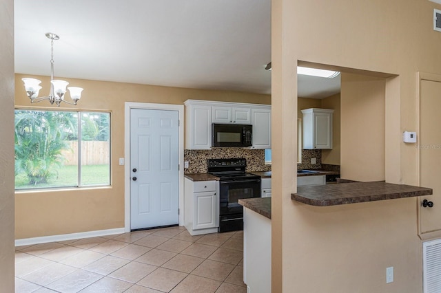 kitchen with decorative backsplash, black appliances, an inviting chandelier, white cabinets, and hanging light fixtures