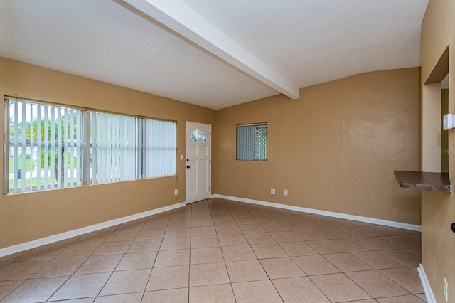 tiled foyer entrance featuring lofted ceiling with beams