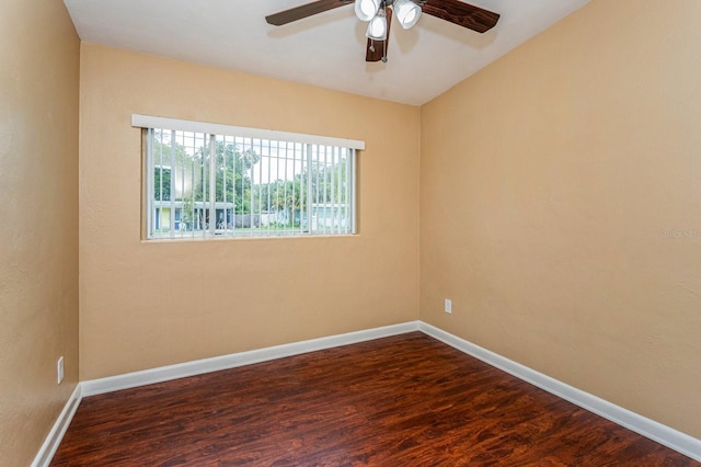 spare room with ceiling fan and dark wood-type flooring