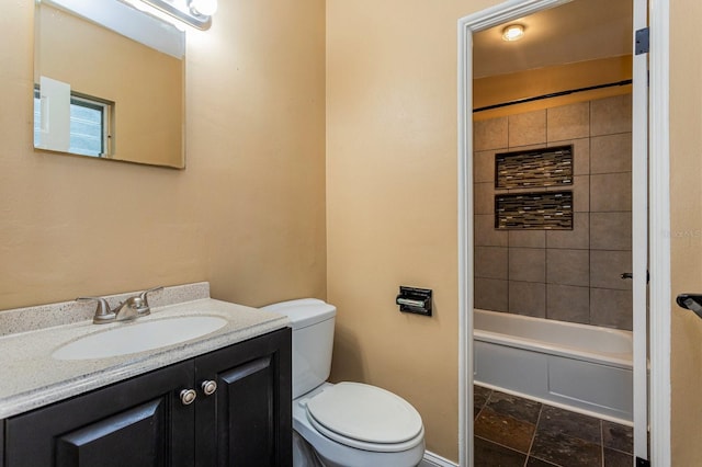 full bathroom with vanity, toilet, and tiled shower / bath