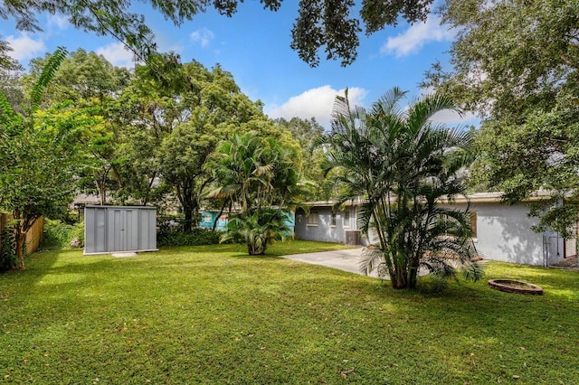 view of yard featuring a patio and a shed