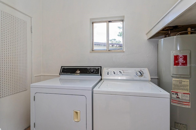 clothes washing area with washer and dryer and electric water heater