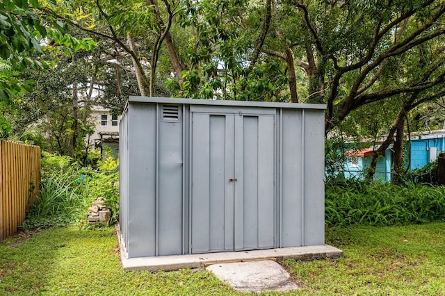 view of outdoor structure featuring a lawn