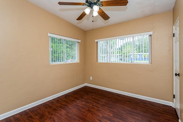 unfurnished room with ceiling fan, dark wood-type flooring, and vaulted ceiling