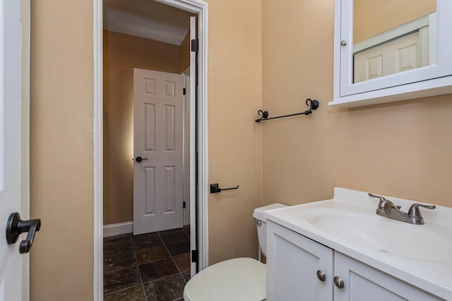 bathroom featuring vanity and toilet