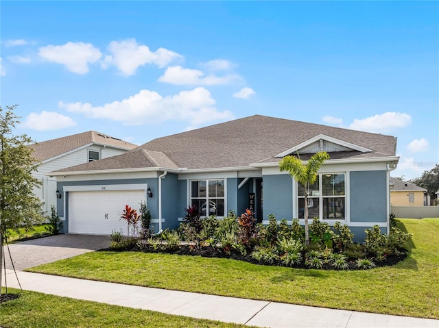 ranch-style house with a garage and a front lawn