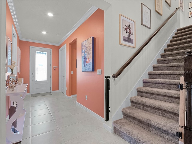 tiled foyer entrance featuring ornamental molding