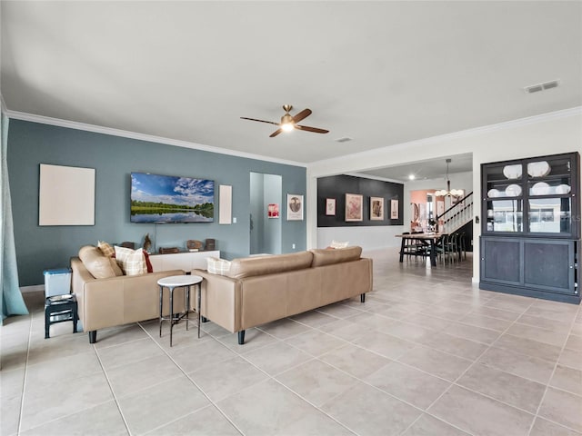 tiled living room featuring crown molding and ceiling fan with notable chandelier