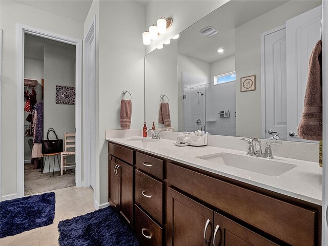 bathroom with vanity, a shower, and tile patterned flooring