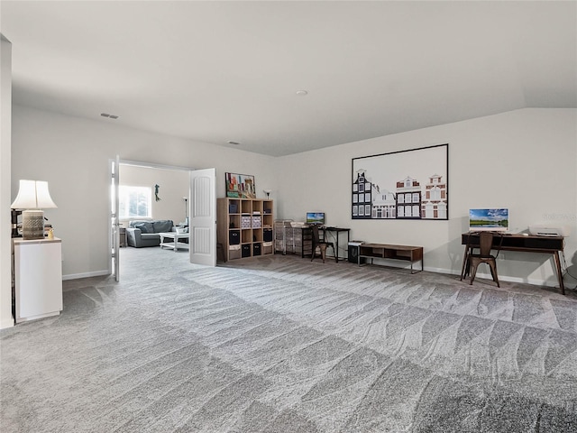 interior space with carpet flooring and vaulted ceiling