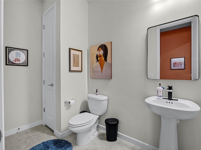 bathroom featuring toilet and tile patterned flooring