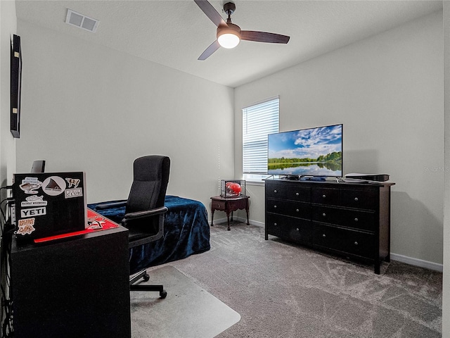 carpeted office featuring ceiling fan