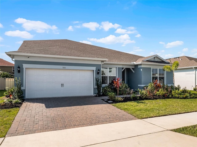 ranch-style home with a front yard and a garage