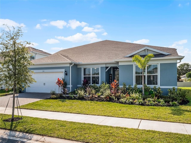 view of front of house with a garage and a front lawn