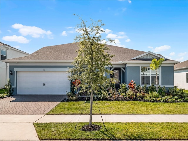 view of front facade with a front yard and a garage