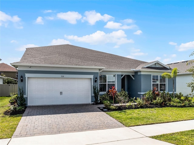 ranch-style home with a front yard and a garage