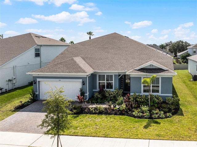 view of front of house featuring a front yard and a garage