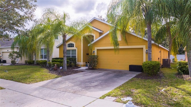 view of front of house featuring cooling unit, a garage, and a front lawn