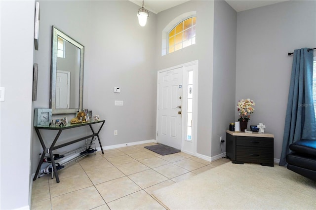 tiled entrance foyer with a high ceiling