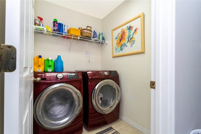 laundry area with light tile patterned floors and washer and dryer