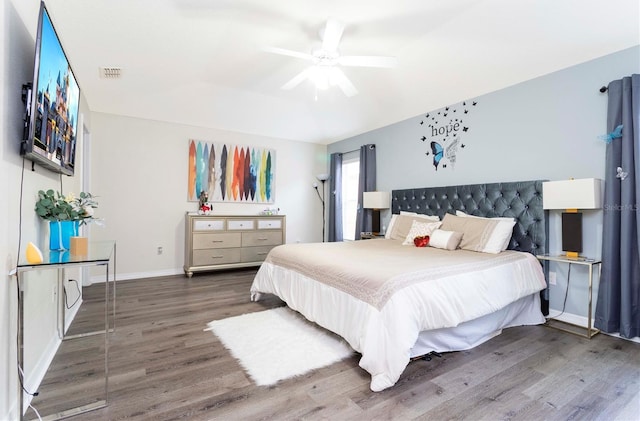 bedroom with ceiling fan and dark hardwood / wood-style flooring