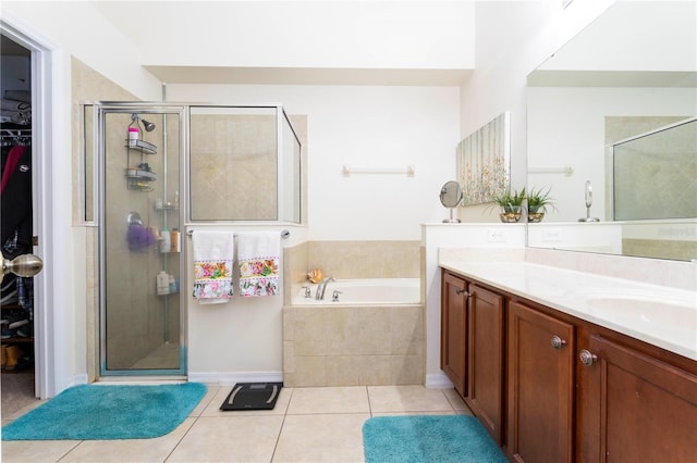 bathroom with independent shower and bath, vanity, and tile patterned floors