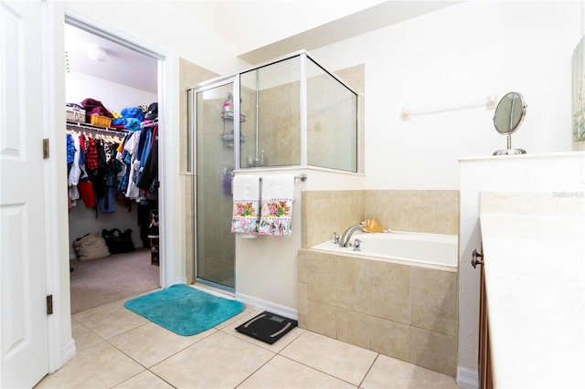 bathroom with tile patterned flooring, vanity, and plus walk in shower