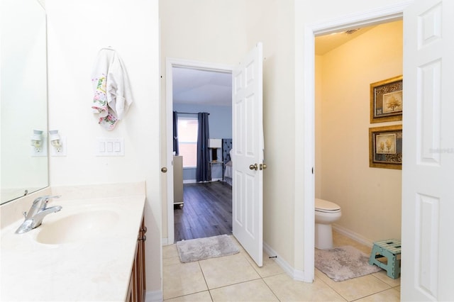 bathroom featuring tile patterned flooring, vanity, and toilet