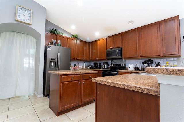 kitchen with light tile patterned flooring, backsplash, stainless steel appliances, lofted ceiling, and a center island