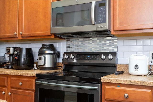 kitchen featuring appliances with stainless steel finishes and backsplash