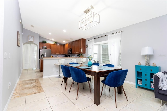 dining room with lofted ceiling and light tile patterned flooring