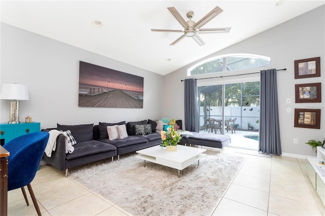 living room featuring vaulted ceiling, ceiling fan, and light tile patterned floors