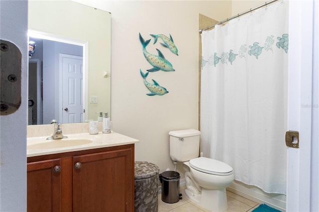 bathroom with tile patterned flooring, vanity, and toilet