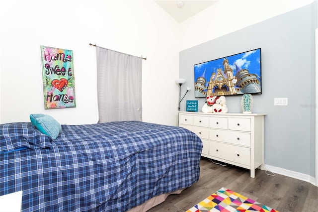 bedroom with dark wood-type flooring