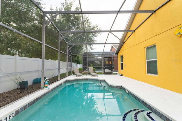 view of pool with a lanai and a patio